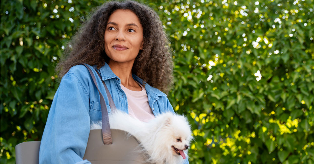 Woman carrying dog