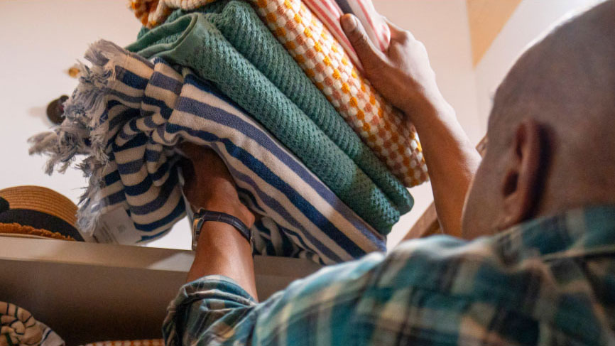 Man carrying folded clothes